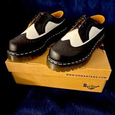 Dr. Martens Black White Saddle Shoes White Oxfords With Round Toe And Rubber Sole, White Oxford Leather Shoes With Cap Toe, White Oxford Leather Shoes With Rubber Sole, White Leather Shoes With Contrast Sole, White Leather Shoes With Brogue Detailing And Round Toe, White Leather Shoes With Brogue Detailing, Casual White Wingtip Dress Shoes, White Lace-up Dress Shoes For Derby, White Oxfords With Perforated Toe Box