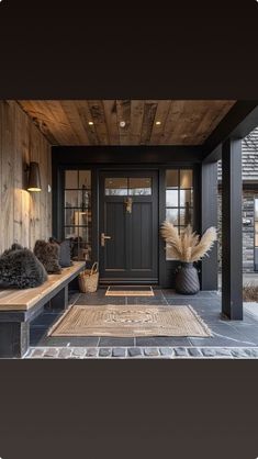 the front porch is decorated with black and wood