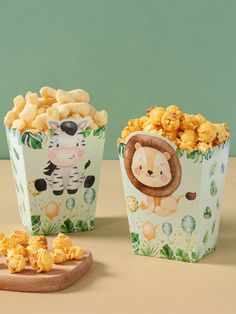 two small boxes filled with popcorn next to each other