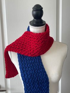 a red, white and blue knitted scarf on a mannequin