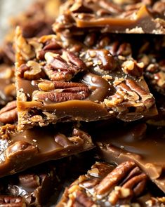 there are many pieces of chocolate and pecans on the table with it's nutty toppings