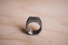 This is a beautiful handcrafted Damasteel, Damascus Steel signet ring in a Heimskringla pattern.The ring pictured is approx. 10mm wide.Each ring is 100% hand made using the highest quality Austenitic stainless Damascus, 95x Damasteel in a dense twist pattern.The ring is then hand polished to give the ring a contrast between the peaks and valleys in the steel. CUSTOM ORDERFor custom made rings, feel free to send me a message and indicate:Desired WidthRing SizeRing MaterialFinish (Gloss or matte)O Handmade Adjustable Engraved Ring For Ceremonial Use, Handmade Adjustable Engraved Ring For Ceremonial Occasions, Unique Engraved Etched Wedding Ring, Unique Engraved Ring For Wedding, Unique Engraved Wedding Ring With Etched Design, Handmade Adjustable Ceremonial Engraved Ring, Artisan Engraved Ring For Wedding, Artisan Engraved Wedding Rings, Unique Carved Engraved Wedding Ring