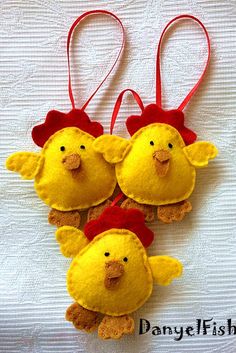 two stuffed chickens hanging from red string