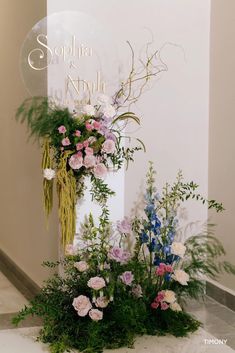 flowers and greenery are arranged in front of a sign that reads, sophina & amph