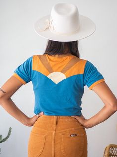 "A new Classic Rock Couture exclusive design! Western style yoke in front with patchwork sunburst design in back. Colors are turquoise, rust and burnt sienna. Contrast stitching and distressed edges add to the vintage look and feel of this super soft 70s style tee. 100% cotton with some stretch... Fitted women's style. More fitted around the neck and sleeves, ringer style. If you are in between sizes, we recommend sizing up. Model Valeria is wearing a SMALL (dark hair) and Jenna and Daniela (blo 70s Style Women, Burnt Sienna, 70s Style, Ringer Tee, Rising Sun, New Classic, Classic Rock, Etsy Fashion, 70s Fashion