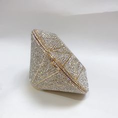 Introducing the 'Diamond' Clutch, an enchanting accessory that adds a touch of sparkling beauty to any evening ensemble. This exquisite three-dimensional dinner bag is adorned with hand-inlaid diamond crystals, creating a beautifully radiant design that captivates from every angle. Perfectly sized for many of your essentials, this mini clutch offers both elegance and practicality. With a base measuring 1.2" in length, a top cover of 5.9" in length, and a height of 3.5", the 'Diamond' Clutch is the ultimate statement piece for your next special occasion, beautifully elevating your style. Diamond Clutch, Diamond Crystal, Dress With Boots, Three Dimensional, Womens Boots, Special Occasion, Women Handbags, Sparkle, Women Shoes