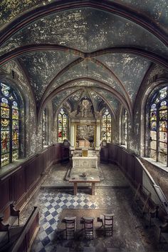 an old church with stained glass windows and pews in the center, is shown