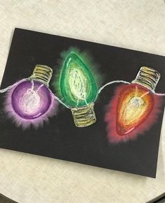 a drawing of three christmas lights on a black paper with colored light bulbs attached to them