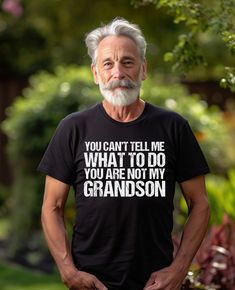 Funny You Can't Tell Me What To Do You're Not My Grandson tee shirt, the perfect gift for all of those cool grandpas out there! This classic unisex jersey short sleeve tee fits like a well-loved favorite. Soft cotton and quality print make users fall in love with it over and over again.  Our Relaxed Fit Tee (Bella + Canvas style 3001) is a unisex style that runs a touch small for men, and about a half a size large for women. It's a relaxed fit and is soft and cozy.  For oversized fit - go up 2 s Funny Grandpa Shirt, Grandpa Tshirts, Grandparents Shirt, Grandpa Funny, Grandpa Shirt, Falling In Love Again, Tshirt Funny, Grandparent Gifts, Grandpa Gifts