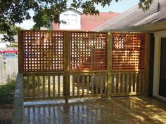 a wooden fence is shown in front of a house