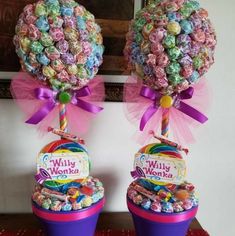 two buckets filled with candy sitting on top of a table