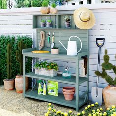 an outdoor garden area with potted plants and gardening tools on a shelf next to a fence