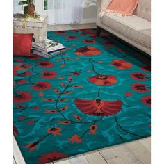 a blue rug with red flowers on it