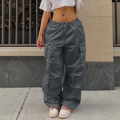 Elevate your loungewear game with our Women Oversized Drawstring Low Waist Parachute Loose Fit Sweatpants. Designed to provide comfort and style, these sweatpants are perfect for the days when you want to stay cozy and relaxed without sacrificing your fashion sense.Crafted from a premium quality blend of materials, these sweatpants are ultra-soft and lightweight, making them perfect for all-day wear. The oversized fit, low waist, and parachute silhouette add a touch of edge to your casual wardrobe, while the drawstring waistband allows for a custom and secure fit.Whether you're running errands, lounging at home, or hitting the gym, our Women Oversized Drawstring Low Waist Parachute Loose Fit Sweatpants will keep you comfortable and stylish. Available in a variety of colors to match any out Cargo Pants Women Baggy, Style Salopette, Clothing Oversized, Celana Kargo, Loose Overalls, Cargo Pants Streetwear, Celana Fashion, Fall Streetwear, Overalls Fashion