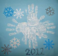 a hand and snowflakes on a blue background with the year 2012 written in it