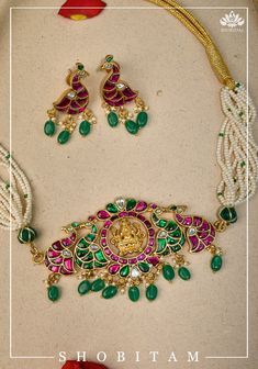 Looking for something aesthetic and Royal? Your search ends with is Multistrand bead choker in shades of white and green. A prominent central unit features a carved Lakshmi design that sets a Divine tone while the jadau stones in peacock designs and hanging beads  balance it with timeless beauty.  This statement piece undoubtedly sits beautifully on your neck! The adjustable closure makes it convenient to wear as well.  The set includes a matching pair of earrings that works graciously with the Luxury Multicolor Jewelry With Peacock Design, Luxury Traditional Jewelry With Colorful Beads, Luxury Bollywood Sets With Peacock Design, Luxury Multicolor Stone Work Jewelry Sets, Luxury Multicolor Jewelry For Puja, Luxury Kundan Chandbalis With Peacock Design, Luxury Multicolor Temple Jewelry Chandbalis, Festive White Peacock Design Necklace, Something Aesthetic