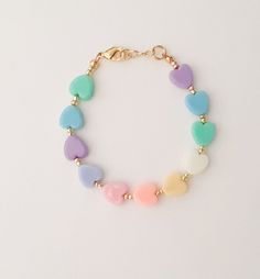 "If you would like to add gold filled hardware to a bracelet, please use this link to purchase it along with the bracelet. You will need to purchase one for EACH bracelet you would like to add gold filled hardware to. https://www.etsy.com/LittleLovliesShop/listing/860546443/gold-filled-upgrade?utm_source=Copy&utm_medium=ListingManager&utm_campaign=Share&utm_term=so.lmsm&share_time=1598757365437 Rainbow Heart Bracelet. These colorful pastel beads are aligned in a rainbow pattern a Handmade Pastel Bracelets For Gift, Everyday Multicolor Jewelry With Heart Charm, Mother's Day Bracelets With Heart Beads, Cute Adjustable Charm Bracelet With Heart Charm, Cute Nickel-free Bracelets For Birthday, Adjustable Heart Beads Bracelet For Birthday, Playful Bracelets With Heart Charm For Gift, Playful Bracelet With Heart Charm For Gifts, Cute Nickel-free Friendship Bracelets