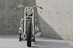 a motorcycle parked in front of a concrete wall