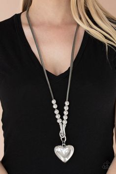 Featuring chunky silver beads, an oversized silver heart pendant swings from dramatic silver hook-like fittings that attach to a bold gray leather cord draped across the chest for a haute heartbreaker look. Features an adjustable clasp closure. Sold as one individual necklace. Includes one pair of matching earrings. P2WH-SVXX-337XX Puffy Heart Necklace, Forbidden Love, Long Silver Necklace, Silver Heart Pendant, Ball Necklace, Paparazzi Accessories, Silver Heart Necklace, Gray Leather, Paparazzi Jewelry