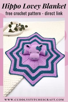 a pink and blue crocheted afghan with an elephant on it's center