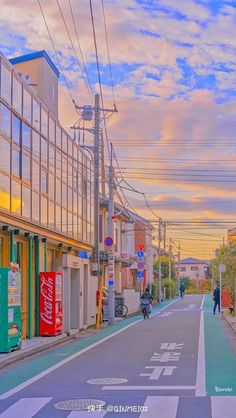 an empty street with buildings and people walking down it