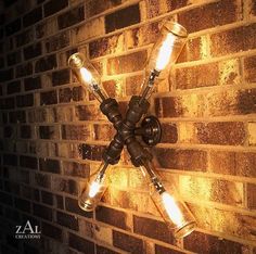 a wall light with three lights on it in front of a brick wall that is lit up