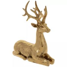 a gold deer figurine sitting on top of a white background