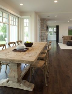 a large wooden table sitting in the middle of a living room