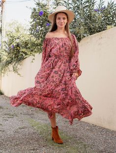 "Our boho off-shoulder maxi dress! Featuring a stunning pink print with black highlights., this dress is perfect for any occasion. Wear it on or off the shoulder, as the elasticated belted waist allows for versatile styling. Crafted from soft and lightweight fabric, this dress is perfect for summer days or tropical getaways. The flowy and relaxed silhouette is flattering for all body types, while the maxi length adds a touch of elegance. Whether you're attending a garden party or enjoying a beach vacation, this boho dress is sure to make a statement. Available in two sizes Measurements  Small/Medium Length 52\"/132cm Bust 32\"/82cm Waist 28\"/71cm Hips max 44\" Sleeve Length 18\"/41cm Sleeve circumference 18\"/ Medium/ Large Length 54\"/137 cm Bust 36\"/91cm Waist 30\"/76cm Hips 50\"/127cm Spring Hippie Flowy Maxi Dress, Hippie Spring Flowy Maxi Dress, Spring Hippie Maxi Dress With Flowy Skirt, Hippie Style Flowy Maxi Dress For Spring, Fall Festival Floral Boho Dress, Flowy Floral Print Hippie Dress, Fall Boho Print Hippie Maxi Dress, Hippie Flowy Floral Print Dress, Hippie Maxi Dress For Beach In Fall