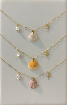 - 14K Gold Filled Paperclip Chain - 18K Gold Plated Pearl Charm - 22K Gold Plated Starfish Charm - 14K Gold Filled Shell Charm - Real Natural Shell - 16 Inch Necklace & 2 Inch Extender If you do decide to wear your jewelry to the beach, consider slipping it off and stowing it in a secure place before you head into the water. All orders will be packaged in a small box along with bubble packaging for the safest of travels to you! Thank you for supporting my small business! - Olivia from The Sandy Poppy <3 Gold Shell Charm Necklaces For Vacation, Gold Shell Charm Necklace For Beach, Gold Shell Necklace For Vacation, Beachy Style, Gold Shell-shaped Necklace For Beach, Elegant Shell-shaped Charm Necklaces For Beach, Shell Charm Necklace, 16 Inch Necklace, Beach Accessories, Pearl Charms