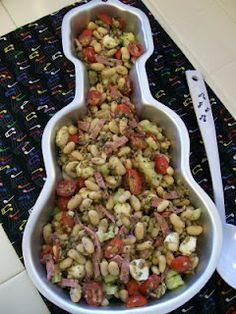 a large bowl filled with lots of food on top of a black and white mat