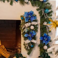 a fireplace decorated for christmas with blue and white decorations