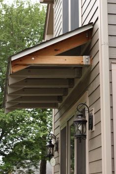 an outside view of a house with some lights on the porch