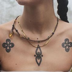 a woman with tattoos on her chest and neck