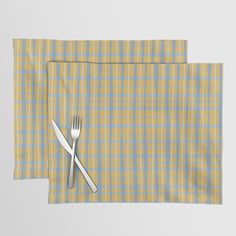 two placemats with forks and knife on them