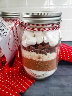 a mason jar filled with marshmallows and chocolate