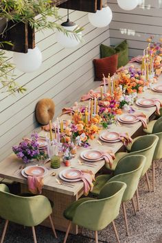 the table is set with many plates and place settings for people to sit down at