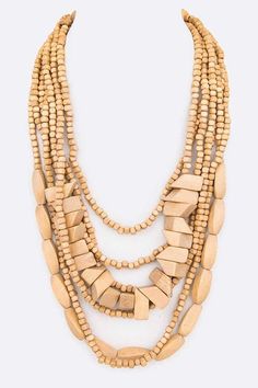 Introducing our Wooden Beads Statement Layered Necklace, expertly crafted with a mix of wooden beads to create a statement piece. With its unique design and high-quality materials, this necklace is perfect for adding a touch of personality to your outfit. Necklace - 22" + ExtensionLead & Nickel Compliant Photo may have been enlarged and/or enhanced