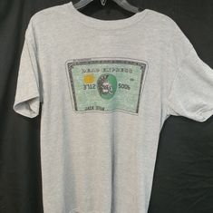 Gray American Express Grateful Dead Shakedown Lot Tee Reprint/Original 100% Dri-Wicking Cotton Feel Poly* Fully Sublimated Graphic To Provide "Zero Hand" To The Graphics And Verbiage Original Reprint (Original Had Stealie) *Also Available In Poly/Cotton Blend Please Reach Out Prior To Purchase Vintage Gray T-shirt With Text Print, 90s Style Short Sleeve Screen Print Shirt, 90s Style Screen Print Short Sleeve Shirt, Gray Graphic Print Band Merch T-shirt, 90s Style Gray Cotton Tops, Vintage Shirt With Front Print For Fans, 90s Crew Neck Shirt With Screen Print, Vintage Tri-blend Top With Text Print, 90s Gray Graphic Print Top