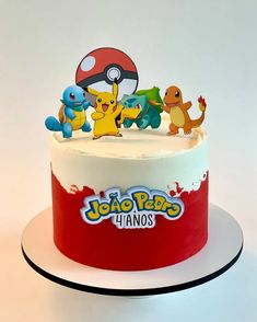 a pokemon themed birthday cake with pikachu and friends on top