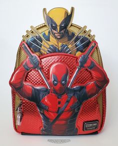 This is a new Loungefly Marvel "Deadpool & Wolverine" Layered Character mini backpack.  This amazing faux leather backpack features Deadpool and Wolverine character appliques, from the latest Deadpool movie, backed by metallic red and gold panels textured to simulate their superhero costumes.  The back and bottom panels and shoulder straps are made with a glittery black faux leather.  A fantastic Marvel themed backpack that is a little larger than most mini backpacks! - Faux leather construction - Deadpool and Wolverine appliques - Zipper closure with X-Men symbol pull - Front pouch with zipper closure and Deadpool symbol pull - Side pockets - Fabric lining with drop pocket - Sturdy chrome hardware - Adjustable padded shoulder straps Dimensions: 13"H x 11”W x 4.5”D This item is new...not p Men Symbol, Deadpool Symbol, Wolverine Character, Deadpool Movie, Superhero Costumes, Pouch With Zipper, Deadpool And Wolverine, Faux Leather Backpack, Mini Backpacks