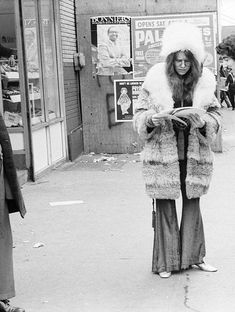 an old photo of two women walking down the street