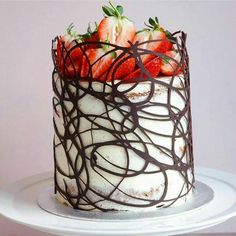 a chocolate covered cake with strawberries on top