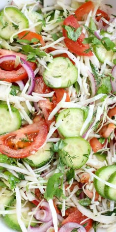 a salad with cucumbers, tomatoes and onions