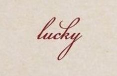 the word lucky written in cursive ink