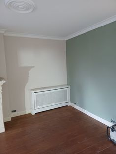 an empty room with a radiator and fireplace in the corner next to it