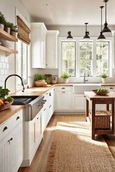 a kitchen filled with lots of white cabinets and wooden counter tops next to a window