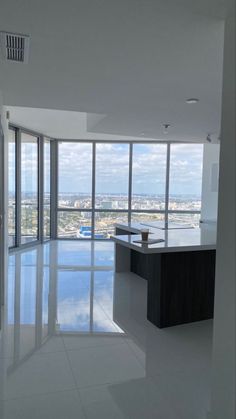 an empty room with large windows and a view of the city from it's floor to ceiling windows