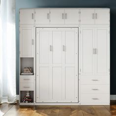 a large white cabinet with drawers in a room