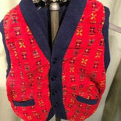 "This is a sweet vintage, toddler's sweater vest from the 50s. Label reads, Wee Men, Styled by Kaynee\". Tagged a size 3. Chest measures 21\", please see measurements below. Made of blue knit with a red print corduroy front. Buttons down the front & has 2 small pockets. The vest is in good condition. No soil, stains. No damage. Too cute! Measurements were taken with the garment laying flat. Please measure your child or a similar garment that fits your child well!! Vintage sizes run smaller t Vintage Cotton Sweater Vest For Winter, Vintage Multicolor Sweater Vest For Winter, Multicolor Vintage Sweater Vest For Winter, Red Cotton Retro Vest, Vintage Red Sweater Vest For Fall, Red Retro Cotton Vest, Retro Red Cotton Vest, Red Vintage Sweater Vest For Fall, Retro Winter Sweater Vest